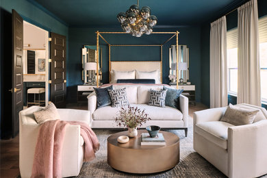 Example of a large transitional master light wood floor and beige floor bedroom design in Austin with blue walls
