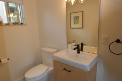 Inspiration for a modern concrete floor, gray floor and single-sink bathroom remodel in Vancouver with light wood cabinets, an integrated sink, white countertops and a floating vanity