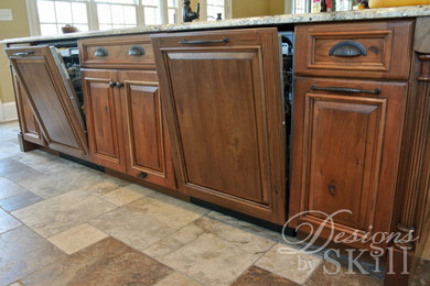 Open concept kitchen - large contemporary l-shaped terra-cotta tile open concept kitchen idea in DC Metro with a double-bowl sink, raised-panel cabinets, dark wood cabinets, granite countertops, beige backsplash, stone tile backsplash, paneled appliances and two islands