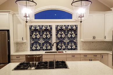 Kitchen - transitional kitchen idea in Other with an undermount sink, recessed-panel cabinets, white cabinets, marble countertops, white backsplash, stone tile backsplash, stainless steel appliances and an island