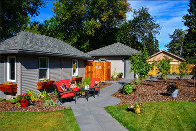 Mid-sized elegant courtyard concrete paver patio photo in Calgary with no cover