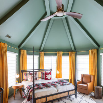 Vaulted Master Bedroom with Exposed Beams and Vibrant Drapery