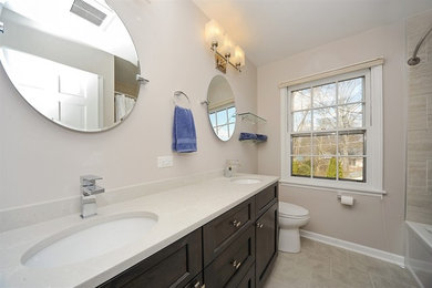 Inspiration for a mid-sized transitional master beige tile and ceramic tile ceramic tile bathroom remodel in Chicago with shaker cabinets, dark wood cabinets, a two-piece toilet, beige walls, an undermount sink, quartzite countertops and white countertops