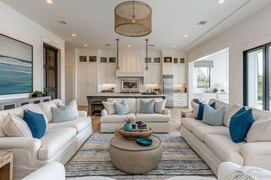 Inspiration for a mid-sized coastal light wood floor and brown floor living room remodel in Las Vegas with white walls