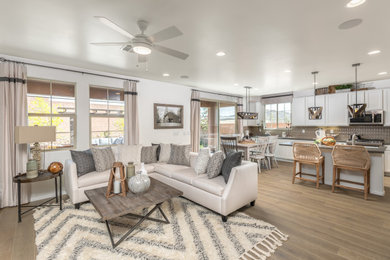 Mid-sized transitional open concept living room in Las Vegas with white walls, light hardwood floors, no fireplace and no tv.