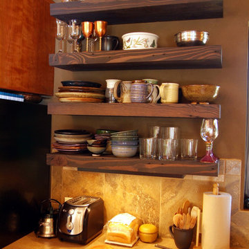Kitchen shelving made from salvaged lumber attached to wall with no visible supp