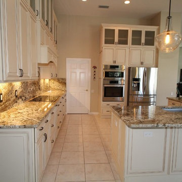 Full height back splash ivory kitchen.