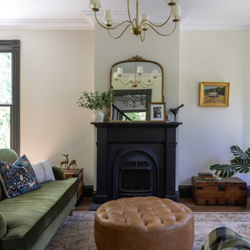Living room with cast-iron fireplace and plaster ceiling medallion