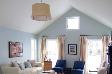 Example of a mid-sized classic open concept light wood floor living room design in New York with blue walls and no fireplace