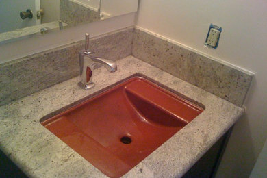Small trendy bathroom photo in San Diego with an undermount sink, flat-panel cabinets, dark wood cabinets, granite countertops and white walls