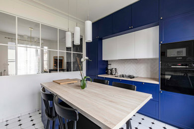 Inspiration for a mid-sized traditional galley open plan kitchen in Paris with laminate benchtops, white splashback, subway tile splashback, ceramic floors, with island, white floor and beige benchtop.