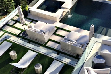 Example of a large minimalist backyard concrete paver patio design in Atlanta with no cover