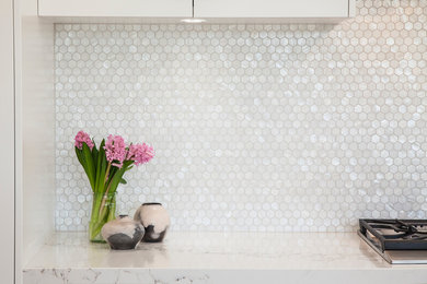Transitional kitchen in Sydney with shaker cabinets, white cabinets, quartz benchtops, grey splashback, mosaic tile splashback and with island.