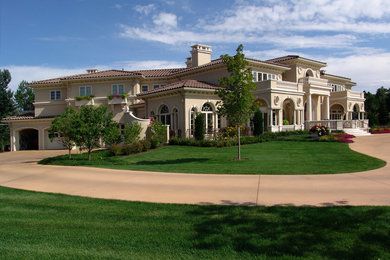 Photo of an expansive mediterranean two-storey stucco beige exterior in Denver.