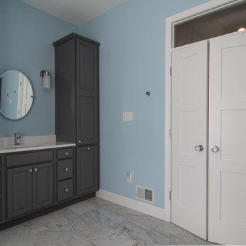 Traditional master bath utilizing frosted and clear glass to allow for needed pr