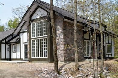 Transitional white stucco exterior home idea in Toronto with a shingle roof