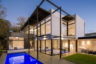 This is an example of a large contemporary two-storey exterior in Melbourne with a flat roof.