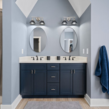 Warm and Cohesive Multi-Bathroom Design In Nokesville
