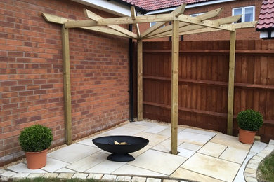 Inspiration for a contemporary back partial sun garden in Other with natural stone paving.