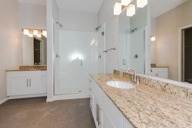 Example of a large trendy master vinyl floor bathroom design in Other with shaker cabinets, white cabinets, granite countertops and gray walls