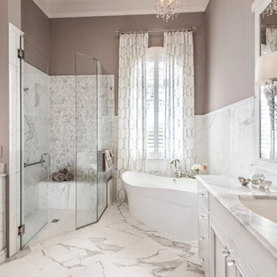 Large transitional master ceramic tile and gray tile marble floor and multicolored floor bathroom photo in Miami with white cabinets, brown walls, an undermount sink, marble countertops, a hinged shower door, multicolored countertops and flat-panel cabinets