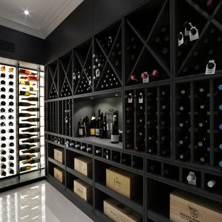 This is an example of a mid-sized eclectic wine cellar in London with marble floors and white floor.