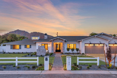 Example of a huge arts and crafts white one-story stucco exterior home design in Phoenix with a shingle roof