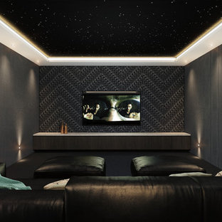 Example of a large minimalist enclosed carpeted home theater design in Melbourne with gray walls and a wall-mounted tv