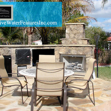 Tropical backyard room with pool waterfall, fireplace, and koi pond