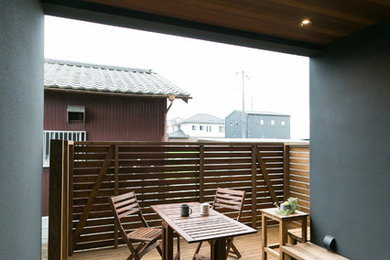 This is an example of a mid-sized modern side yard deck in Other with an outdoor kitchen and a roof extension.