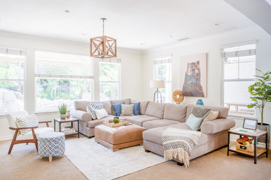 Inspiration for a mid-sized transitional open concept living room in Orange County with white walls, carpet, a standard fireplace, a brick fireplace surround, a built-in media wall and beige floor.