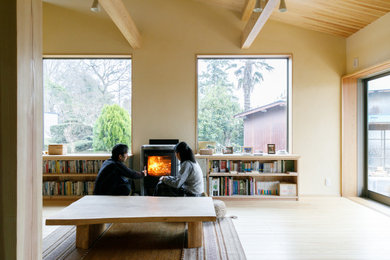 Design ideas for an asian living room in Other with medium hardwood floors, a wood stove and a stone fireplace surround.