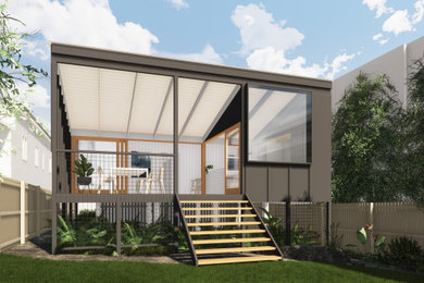 Small contemporary one-storey black house exterior in Brisbane with mixed siding, a flat roof and a metal roof.