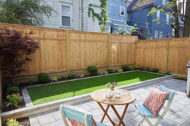 Inspiration for a small modern partial sun backyard concrete paver landscaping in New York.