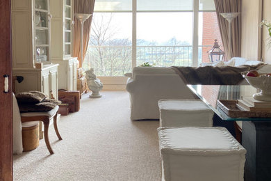 Living room - large eclectic loft-style carpeted and beige floor living room idea in New York with beige walls, no fireplace and a media wall