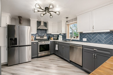 Example of a mid-sized transitional vinyl floor eat-in kitchen design in Columbus with shaker cabinets, quartz countertops, blue backsplash and an island