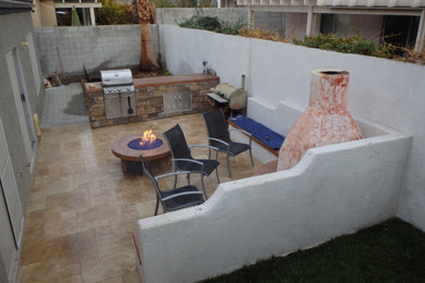 Patio kitchen - mid-sized rustic backyard stone patio kitchen idea in Las Vegas with no cover