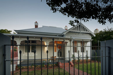This is an example of a mid-sized traditional one-storey red exterior in Perth with concrete fiberboard siding and a flat roof.