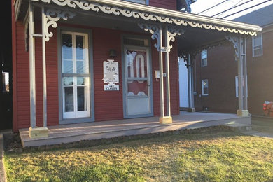 Elegant front porch photo in Other with decking
