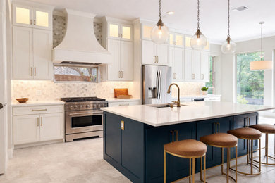 Large transitional l-shaped porcelain tile and gray floor eat-in kitchen photo in Dallas with an undermount sink, shaker cabinets, white cabinets, quartzite countertops, white backsplash, porcelain backsplash, stainless steel appliances, an island and white countertops
