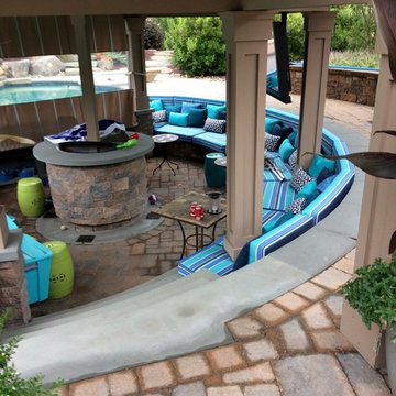 Outdoor living space with pool and sunken bar, plus cabana