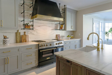 Eat-in kitchen - mid-sized transitional l-shaped ceramic tile eat-in kitchen idea in New York with a farmhouse sink, flat-panel cabinets, gray cabinets, marble countertops, white backsplash, marble backsplash, paneled appliances, an island and white countertops