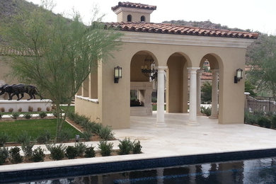 Patio - mid-sized traditional backyard stone patio idea in Phoenix with a fire pit and a roof extension