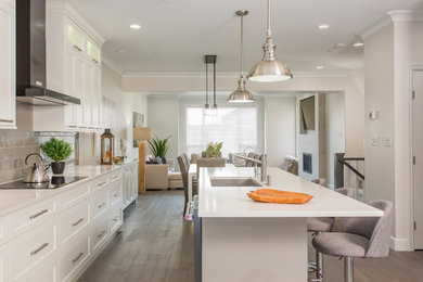 Inspiration for a modern galley dark wood floor kitchen remodel in Vancouver with shaker cabinets, white cabinets, quartz countertops, gray backsplash and an island