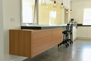 Inspiration for a large contemporary u-shaped open plan kitchen in Sydney with flat-panel cabinets, white cabinets, quartz benchtops, porcelain floors, an undermount sink, stone slab splashback and stainless steel appliances.