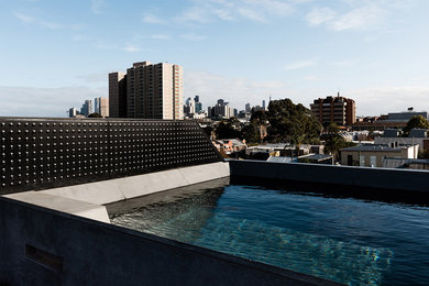 Design ideas for a small contemporary rooftop rectangular aboveground pool in Melbourne with concrete slab.