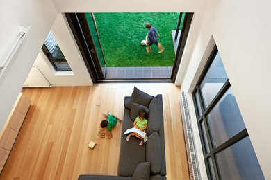 Contemporary sunroom in Melbourne with medium hardwood floors.