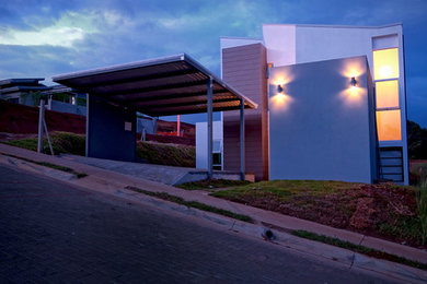 Inspiration for a contemporary white two-story concrete exterior home remodel in Other
