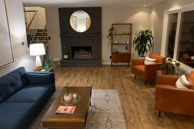 Mid-sized mid-century modern open concept light wood floor and beige floor living room photo in Portland with gray walls, a standard fireplace, a brick fireplace and no tv