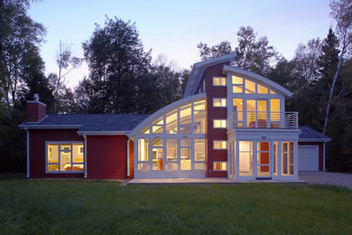Photo of a mid-sized modern two-storey red house exterior in Chicago with concrete fiberboard siding.